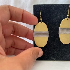 Gold oval earrings with silver wrap.